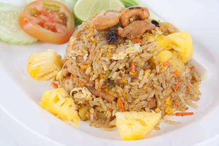 Fried rice with seafood served in a pineapple isolated on white backgroundの写真素材