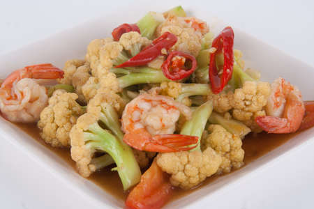 Stir fried cauliflower with tomato and shrimp on a plate.の写真素材