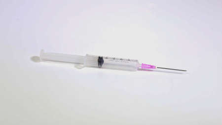 Empty syringe closeup isolated on white background.