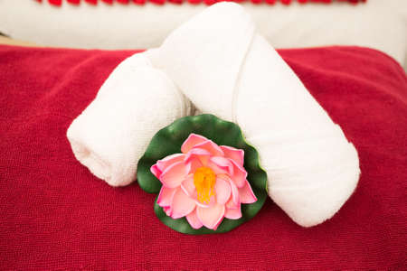 Clean towels on bed in spa roomの写真素材