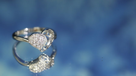 Diamond ring on dark blue background,wedding ring, engagement ringの写真素材
