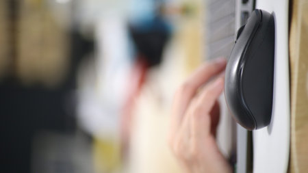 Click black computer mouse on a work desk. Working with a PC or laptop at workplace, close-upの写真素材