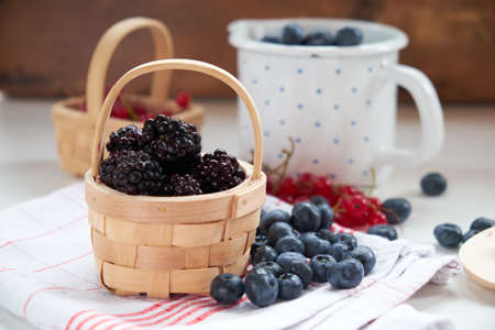 Blueberry, red currant and blackberry mix on wooden backgroundの写真素材