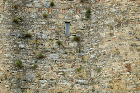 Closeup of ancient grey brown stone wallの写真素材