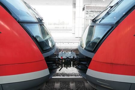 Two red train carriages at the stationの写真素材