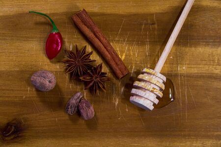 Spices, honey and chili on cutting boardの写真素材