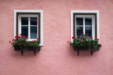 View of traditional Alps house with windows and flowersの写真素材