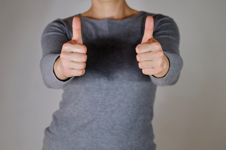 Woman holding two thumbs upの写真素材