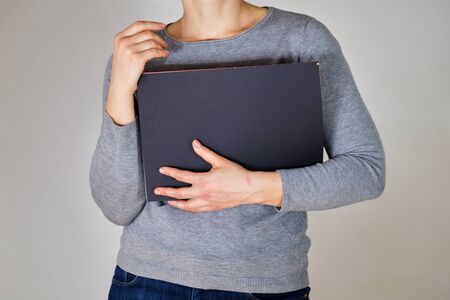 Woman holding grey folder with papersの写真素材