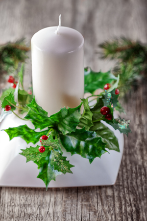 Christmas symbols including Candle on a wooden tableの写真素材