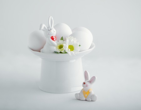 Easter symbols - Eggs and Bunny on a white tableの写真素材