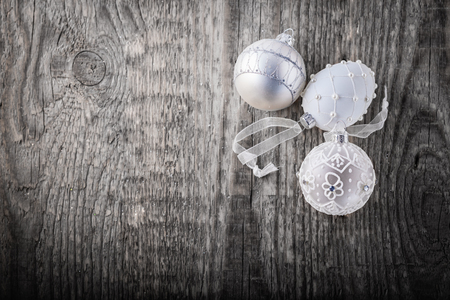 Natural wooden background with white christmas ballsの写真素材