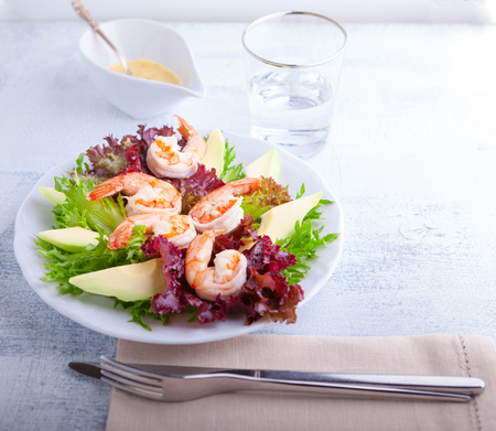 Avocado shrimp salad with mustard sauce on the table.の写真素材