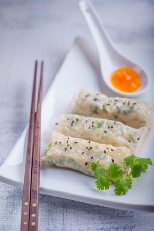 Spring Rolls with Sauce on a wooden surface.の写真素材
