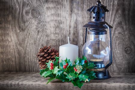 Christmas ornaments and candle light on rustic wood.の写真素材