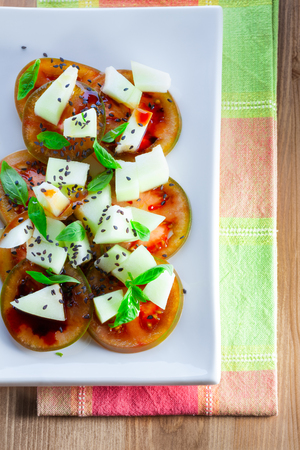 Tomato salad with melon, cheese basil sesameの写真素材