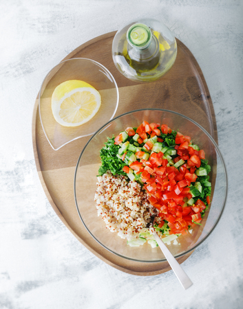 Quinoa tabbouleh salad on a wooden table.の写真素材