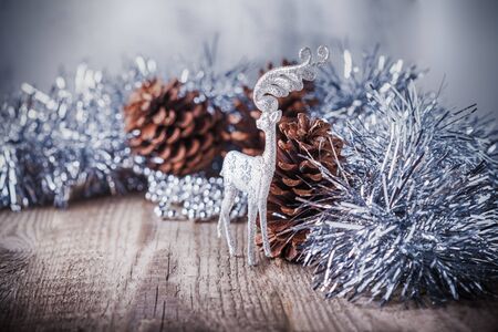 Home decor pine cones  and white deer on a wooden background. の写真素材