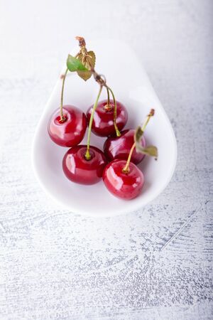 Cherries in a white dishの写真素材