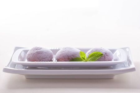 Chocolate coconut mochi ice cream on white background.の写真素材