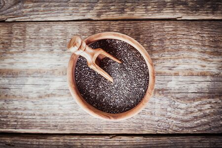 Chia Seeds with a spoon on a wooden table.の写真素材