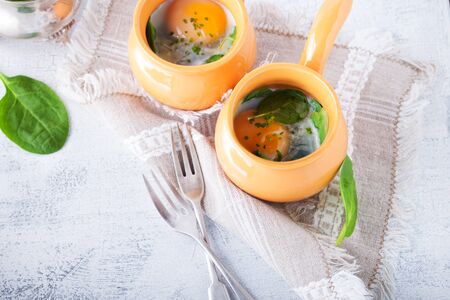 Baked eggs with spinachの写真素材