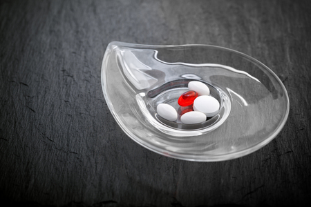 Pills on a stone plateの写真素材