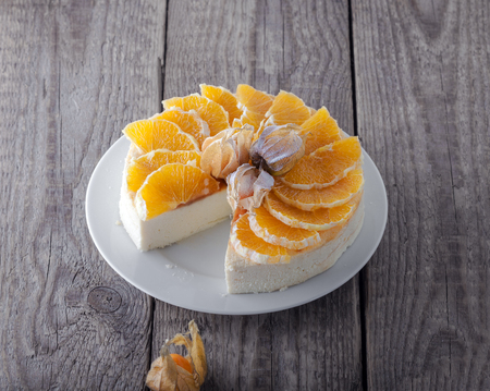 Cheesecake decorated with oranges and physalisの写真素材