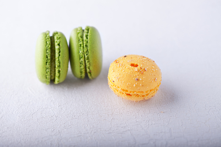 Almond cookies French macaroons on a white surfaceの写真素材