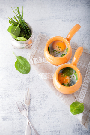 Baked eggs with spinachの写真素材
