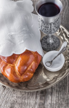 Wine, challah on a wooden surfaceの写真素材