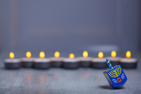 Defocused lights of Jewish holiday Hanukkah and spinning topの写真素材