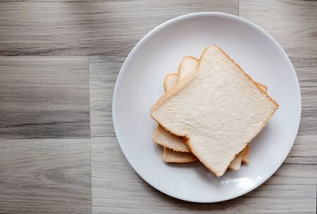 Toasted 3 slice of bread on white plate , Wide angel on the table , Selective focus