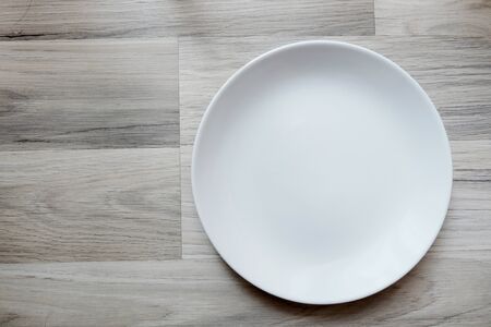 Empty plate on wooden backgroundの写真素材