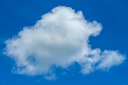 Beautiful white fluffy clouds on bright blue skyの写真素材