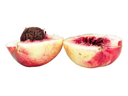 Two halves of a peach isolated over white backgroundの写真素材