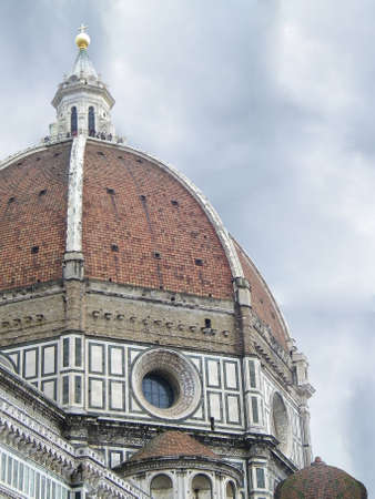 The dome of the cathedral of Florence under a cloudy skyの写真素材