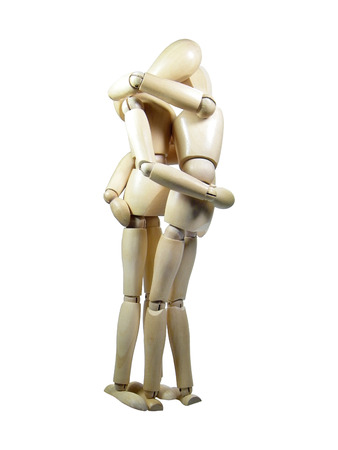 Two wood puppets kissing each other isolated over white backgroundの写真素材