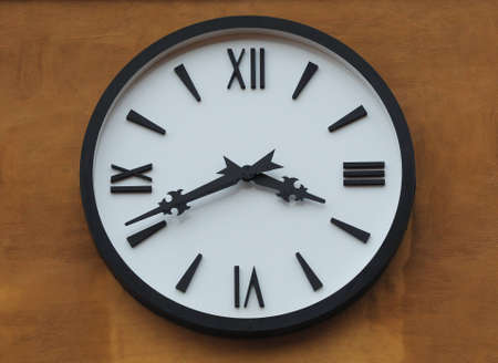 clock on brown wallの写真素材