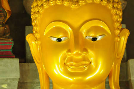 closeup face of golden buddha statueの写真素材