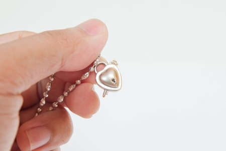 platinum pendant on hand and white background