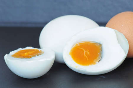 Eggs Salted cut in half on black backgroundの写真素材