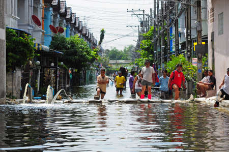 People are speeding up their pumping out of the village. this flood is a most serious flooding in decades. flooding of November 06, 2010 in Bangkok, Thailand.のeditorial素材