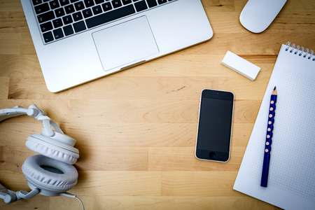 desk with computer, paper and phoneの写真素材