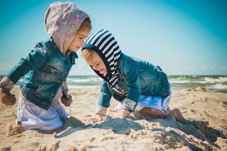 two girls playing on the beachの写真素材