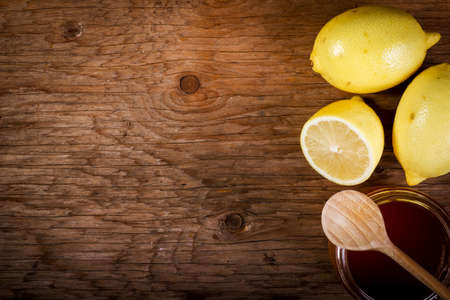 lemon and honey on a wooden tableの写真素材