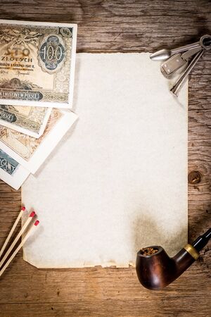 Pipe, old paper and old moneyの写真素材