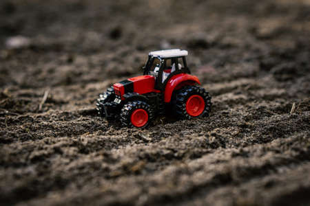 small toy tractor on the fieldの写真素材