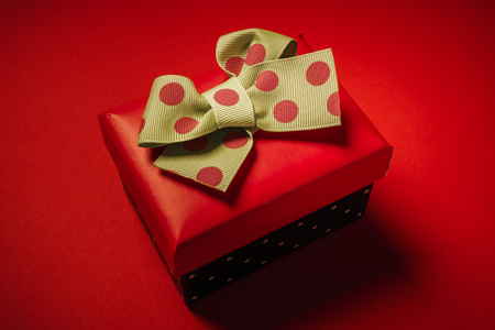 small gift for Valentines Day on a red backgroundの写真素材