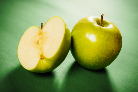 Two fresh green apples on a colored backgroundの写真素材